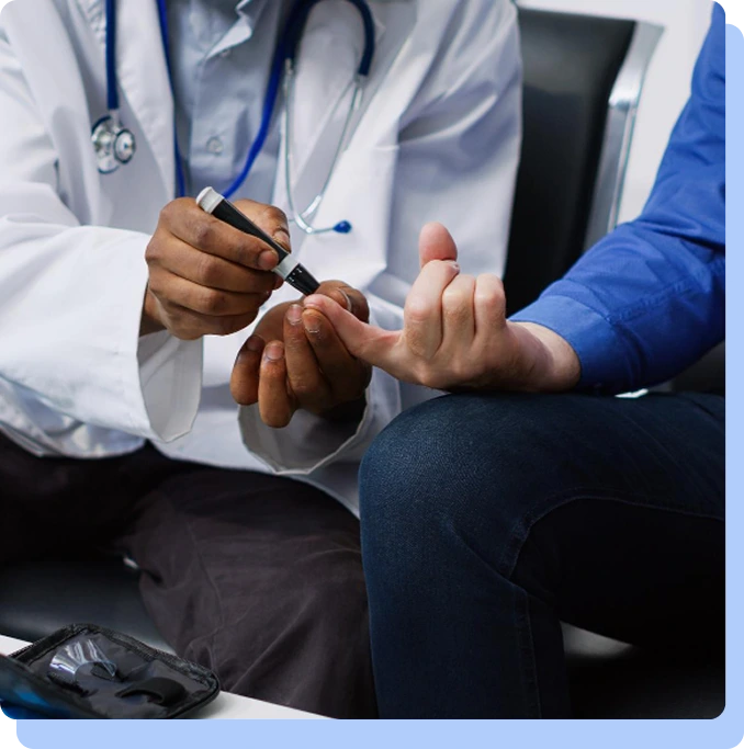 A doctor in a white lab coat performing a finger-prick blood test on a patient to check glucose levels during a medical consultation.
