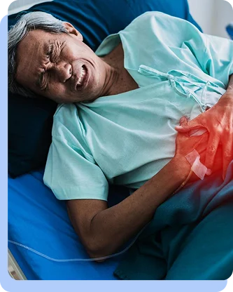 An elderly person lying in a hospital bed, grimacing and holding their side in apparent pain or discomfort.
