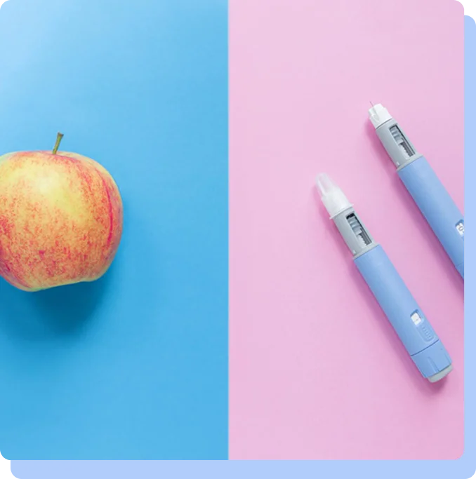 A split-screen composition. The left half has a blue background featuring a single red and yellow apple. The right half has a pink background featuring two blue medical injector pens laid diagonally.