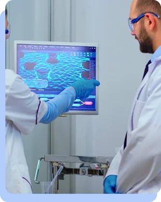 Two researchers in white lab coats and protective eyewear look at a clipboard featuring a world map with arrows indicating global connections or data flow.