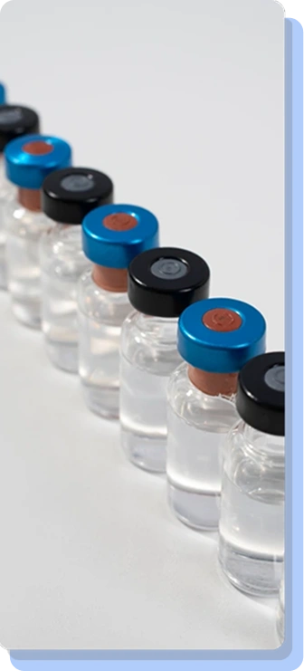 A diagonal row of clear medical glass vials with blue and black caps, representing the ongoing and structured nature of a multi-week treatment plan.