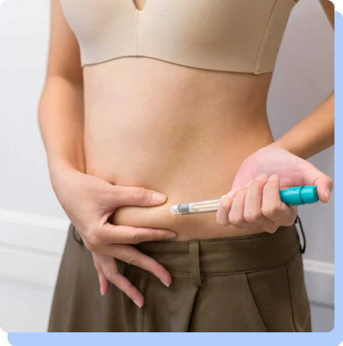 A person using an injection pen on their abdomen for a weekly medication dose.
